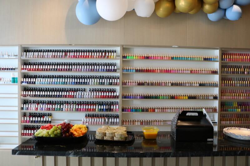 Marble reception bar and polish wall at NailVibe Cool Springs