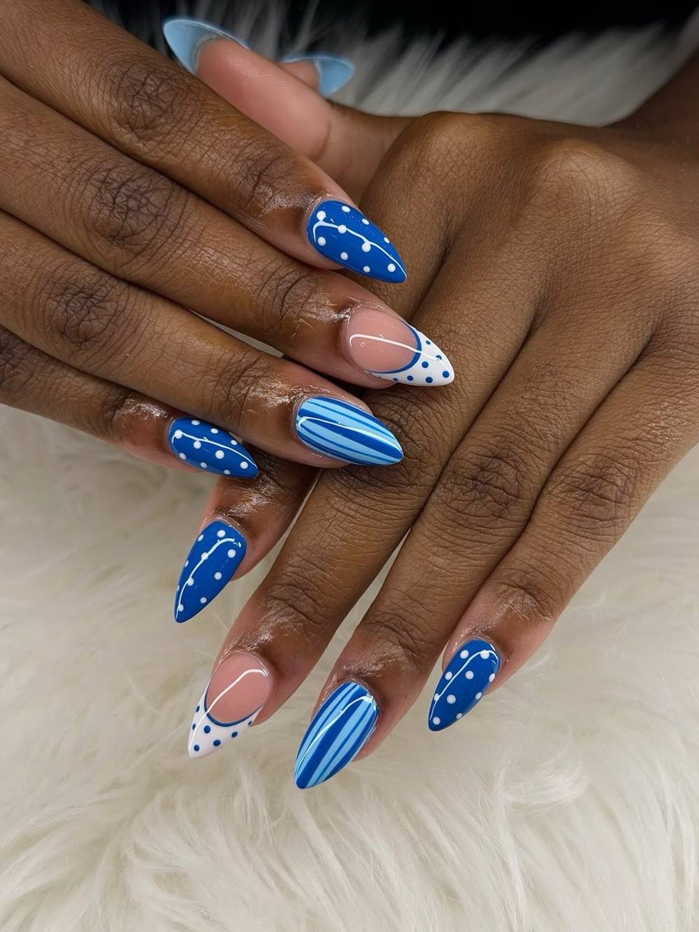 Blue almond nails with polka dots and swirls